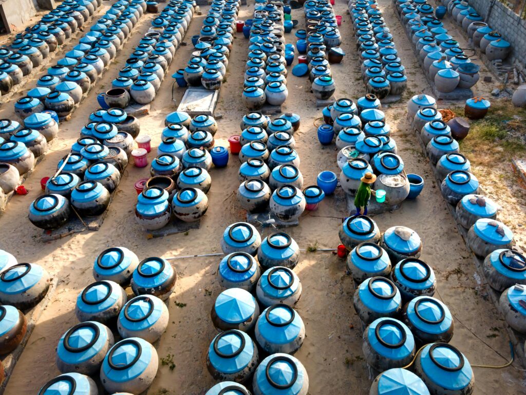 Worker Walking among Barrels